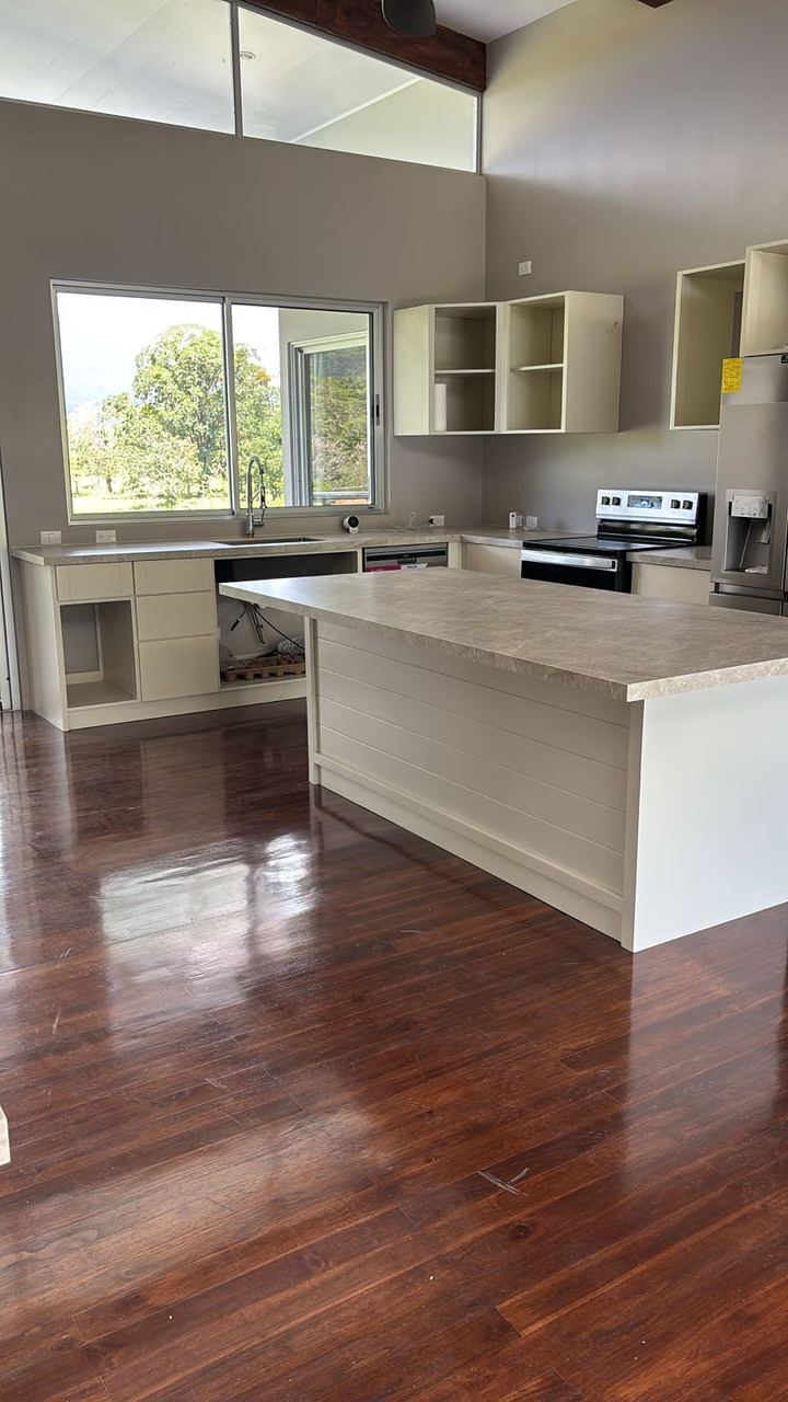 Installed teak flooring in a finished kitchen